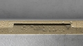 hansgrohe-raindrain-flex-element-zewnetrzny-zloty-optyczny-zblizenie-sciana.jpg